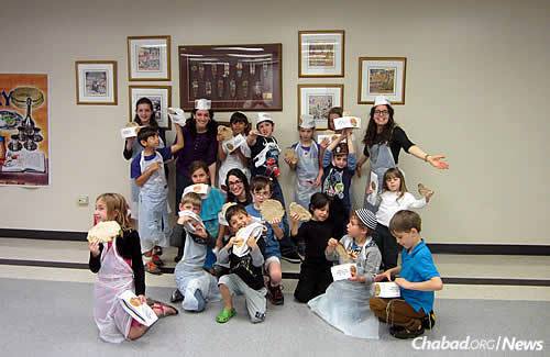 Kids at the Chabad Center of Metairie participate in a “Model Matzah Bakery” workshop, another “Living Legacy” program.