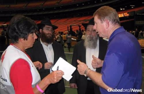 Rabbi Mendel Rivkin, left, and Rabbi Zelig Rivkin, shown 10 years ago in Houston&#39;s Astrodome consulting with authorities on identifying Jews who were stranded as a result of Hurricane Katrina.