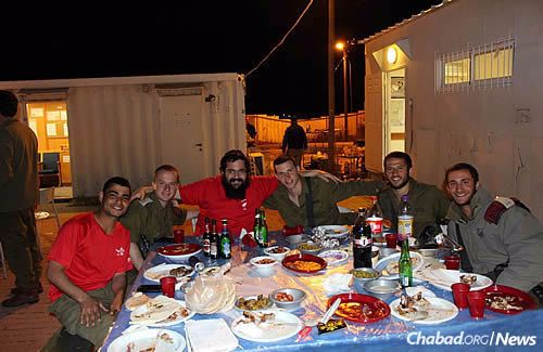 An evening food break for soldiers in Hebron, sometimes with dishes that remind them of home.