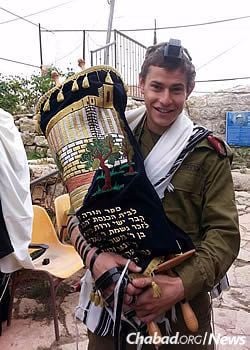 Holding the Torah in this bar mitzvah year.