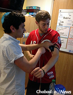 Putting on tefillin, which Moscot admits he has neglected in the years following his bar mitzvah.