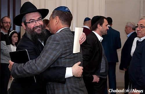 Rabbi Pinchas Vishedski, Donetsk’s chief rabbi and Chabad-Lubavitch emissary, greets members of the Jewish community of Donetsk now living in Kiev. They fled to Ukraine's capital because of ongoing fighting, unrest and volatile living conditions in the easternmost part of the country.
