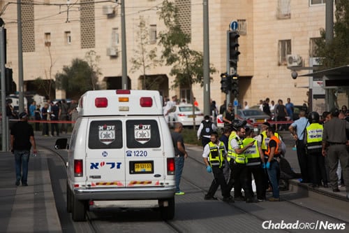 Rescue personnel at the scene of a stabbing attack in the northern Jerusalem neighborhood of Pisgat Ze&#39;ev. A 13-year-old was stabbed by a terrorist while riding his bicycle. The boy is hospitalized in critical condition. (Photo: Yonatan Sindel/Flash90)
