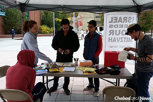 Also at Binghamton, student leaders and Rabbi Levi Slonim—director of programming and development at the Chabad center there—set up a table in the center of campus last Wednesday, encouraging students and faculty to do a mitzvah for Israel. (Photo: Chabad of Binghamton)