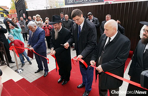 Lazar, second from left, and Rabbi Mendy Zaklas of the Jewish community of Bryansk, right, joined with local leaders, and city and regional administrators to cut the official ribbon at the grand opening.