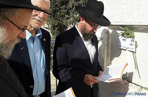The Raichik group at the grave of Alon Govberg, who was killed in a bus attack one week ago and has no family in Israel. The men organized a minyan at his grave site to say Tehillim and Kaddish, making the end of the shiva (mourning) period.