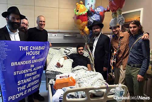 At Hadassah Ein Kerem Medical Center in Jerusalem are Rabbi Peretz Chein, left, executive director of the Chabad House at Brandeis University in Waltham, Mass., who came with a local delegation to visit Israeli terror victims and their families. To his right are Rabbi Menachem Kutner, director of the Chabad Terror Victims Project; Rabbi Yisroel Naftalin, the hospital&#39;s Chabad emissary; and Brandeis student Tzvi Miller, far right, with his brother, Netzach, who lives in Israel.