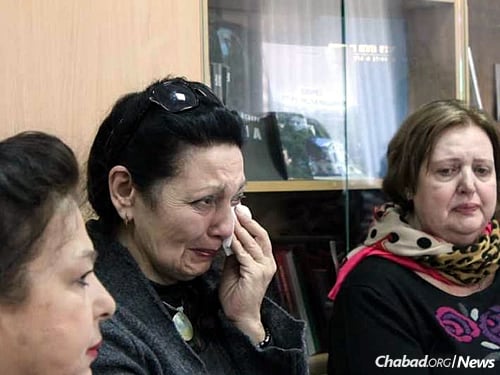 A Jewish refugee from eastern Ukraine reacts emotionally as she tells her story.