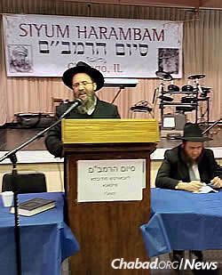 Rabbi Mordechai Farkash, co-director of the East Side Torah Center-Chabad in Bellevue, Wash., speaks at a prior Siyum HaRambam celebration.