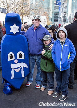 A family poses with the dancing dreidel at Chanukah festivities in Detroit.