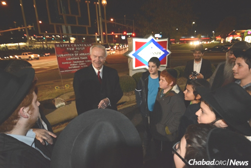 Arkansas Gov. Asa Hutchinson converses with Mechinah students at the state’s annual outdoor menorah-lighting celebration.