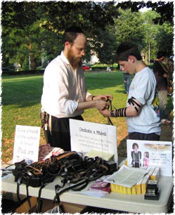 Donning tefillin at the Israel Solidarity Rally in New Jersey