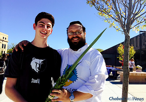 Rabbi Tiechtel on campus, offering students the mitzvah of shaking the lulav and etrog during Sukkot