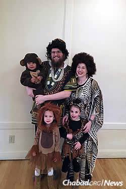 With her parents, Rabbi Chaim and Chavie Bruk, and siblings at a previous Purim