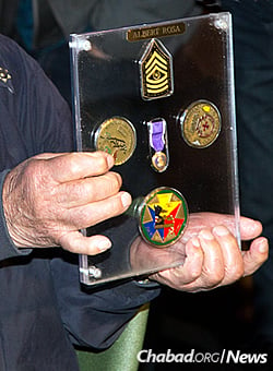 Rosa displays his five medals, including a Purple Heart, from the U.S. Army. (Photo: Ryan Arb)