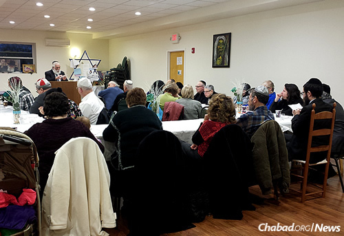 Rabbi Yisroel Rubin of Albany, N.Y., marks a milestone with a group of Jews in Kingston, N.Y., who recently completed the study of the entire “Kitzur Shulchan Aruch,” the popular abridgement of the “Code of Jewish Law.”