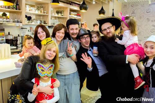 Purim at Chabad on Michurinskiy, one of a handful of Chabad centers that opened this year in Moscow. It&#39;s led by Rabbi Shimon Krasnodomskiy, far right, and his wife, Chana, front left.