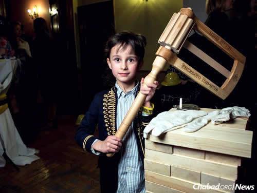 A child holds an oversized grogger at the International Jewish Community of Moscow's annual Purim party. A total of 28 Chabad centers now dot the Russian capital. (Photo: International Jewish Community of Moscow)