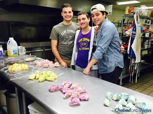 Displaying a twist on classic-colored challah dough—an activity that was part of their particular Hakhel gathering—are, from left, David Basher, Noah Safon and Jordan Hill. (Photo: Chabad of Binghamton )
