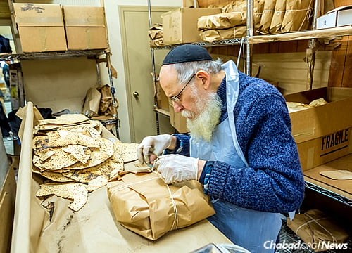 Busy at work in a matzah bakery in Brooklyn, N.Y., right before the eight-day holiday of Passover. (Photo: Eli Parypa/Chabad.org)