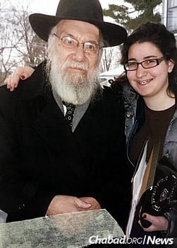 Bracha Kosofsky distributed shmurah matzah with her grandfather a few years before his passing at age 90.