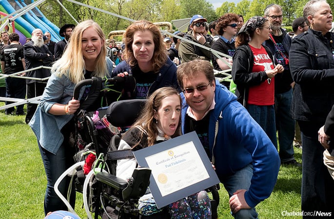 Peri Finkelstein received the 2016 Ambassador Award on May 15 at the Long Island “Walk 4 Friendship,” sponsored by the Chabad-run Friendship Circle in West Hempstead, N.Y., in honor of her stellar participation in the 2016 Miami Marathon. Accompanying her are her sister, Katy; her mother, Lori; and her father, Paul. (Photo: Gary Rabenko)