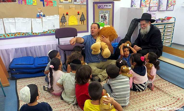 Rabbi Mendel Lieberman, right, founder of Chabad’s “Chai Ashkelon” program, with some of the 1,200 hospitalized children in Israel who will get to participate in summer camp this year, the program&#39;s 35th year running.