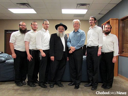 Darryl Tocker, third from right, enjoys the fact that the rabbis come to teach and educate.