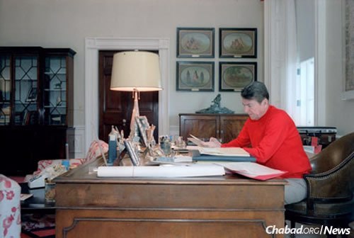 President Ronald Reagan working in his residence study on April 15, the day he wrote the letter to the Rebbe. (Photo: The Reagan Library)
