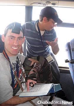Laible Schmidt on an airplane back from a Birthright Israel trip for adults with special needs. Here, he helps his seatmate don tefillin and recite the Shema.
