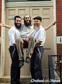 From left: Rabbi Shmuli Rothstein, Newman and Rabbi Shmuel Weinstein, director of the Chabad House at the University of Pittsburgh