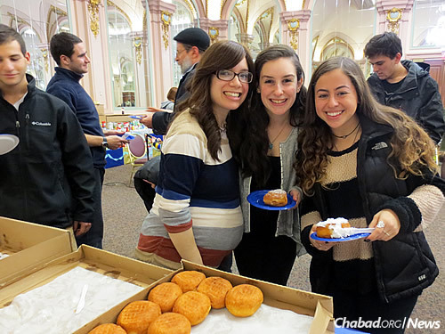 Chasi Rothstein with Pitt students Haley Platt, center, and Jamie Barishman at a Chanukah festival on campus (jelly doughnuts included).