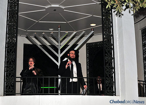 The rabbi at the event; to his left is an American Sgn Language interpreter. To his right is Mayor Sandy Stimpson, who lit the shamash (“helper candle”) on the 9-foot menorah.