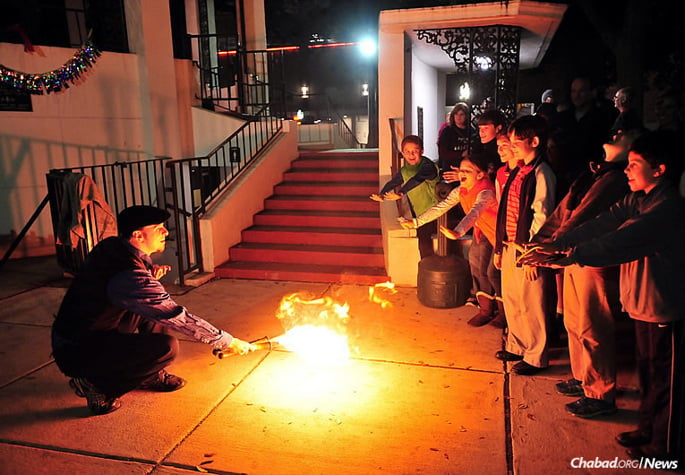 Children in Mobile, Ala., are looking forward to Chanukah again this year. Above, a performance at the Southern city&#39;s first public menorah-lighting, organized two years ago by Rabbi Yosef and Bina Goldwasser, co-directors of the Chabad House there.