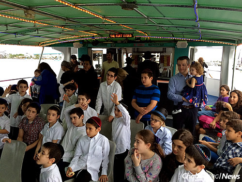 Children from Maimonides, some with family members along, enjoy a Chanukah cruise.