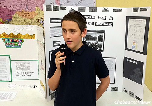 Peretz Meir Simcha Minkowicz, one of the Chabad couple’s children, presents his science-fair project.