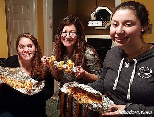 Danielle Fox, left, a psychology and elementary-education major, wanted a Chabad presence on campus after meeting students around the country during a summer trip to Israel who were active with Chabad at their own schools. Here, she makes challah with Shaina Rapoport and Danielle Albilia, right, at the new Chabad at Stockton University.
