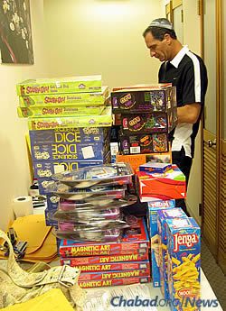 Stacking up toys and board games to be wrapped and distributed. (Photo: Courtesy of the Aleph Institute)