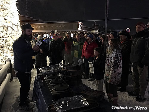 Rabbi Zalman Mendelsohn, co-director of Chabad-Lubavitch of Wyoming, offers hot food on a cold night at a Chanukah menorah-lighting in Jackson Hole.