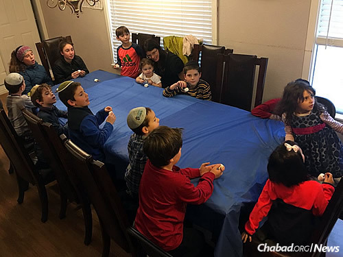 Members of the Kids Club in Wyoming learn about Chanukah traditions, while playing dreidel and eating latkes.