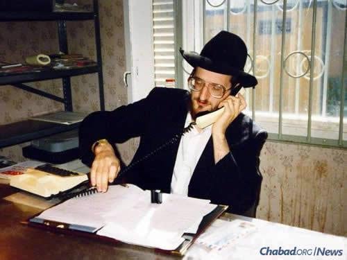 Rabbi Berel Lazar, today the chief rabbi of Russia, works a telephone in an office in the old Marina Roscha synagogue in Moscow, circa 1991. The early 1990s were exceedingly difficult for Lazar and his fellow emissaries; food and other necessities were scarce, and they struggled to raise funds to keep their operations going.