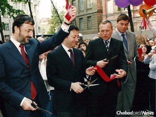 Philanthropist Lev Leviev's investment in Jewish education and community throughout the former Soviet Union changed circumstances for Jews there from despair to hope. Here, Leviev, second from left, cuts the ribbon to Kharkov's newly renovated synagogue, along with New York philanthropist and investor George Rohr, left. The Rohr family was also instrumental in building the former Soviet Union's Jewish infrastructure, as it is in Chabad's growth on university campuses around the world.