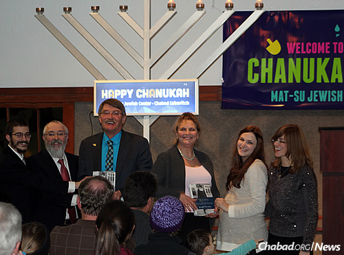 At the 2015 Chanukah menorah-lighting and family event are, from left: Rabbi Mendy Greenberg, co-director of the Mat-su Jewish Center Chabad Lubavitch in Wasilla, Alaska, with his father, Rabbi Yosef Greenberg, director of the Lubavitch Jewish Center of Alaska in Anchorage; Mayor of Wasilla Bert Cottle; Mayor of Palmer DeLena Johnson; Chaya Greenberg, co-director of the Wasilla Chabad; and Esther Greenberg, co-director of the Anchorage Chabad.