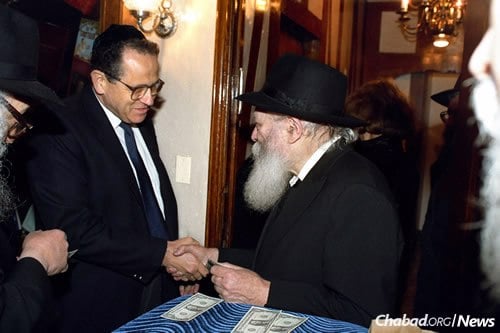 Yosef Ciechanover receives a dollar and a blessing from the Rebbe. Ciechanover held numerous Israeli government posts, including director general of the Foreign Ministry, legal adviser to the Defense Ministry and head of Israel’s defense mission to the United States. (Photo: Jewish Educational Media/The Living Archive)