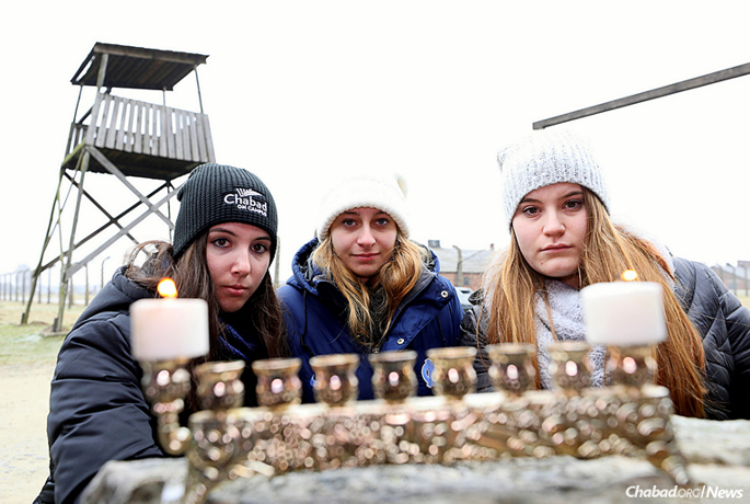 Students from dozens of universities across North America spent six days in Poland as part of Chabad on Campus International’s first heritage trip to explore Jewish life there. They lit the first candle of Chanukah in Auschwitz. (Photo: Bentzi Sasson)