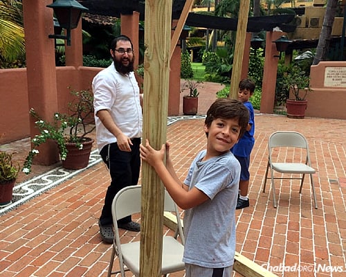 The rabbi gets a little help with putting up and taking down the sukkah.